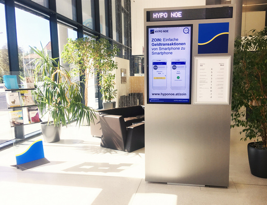 foyer of hypo noe headquarters in austria with spinetix digital signage totem
