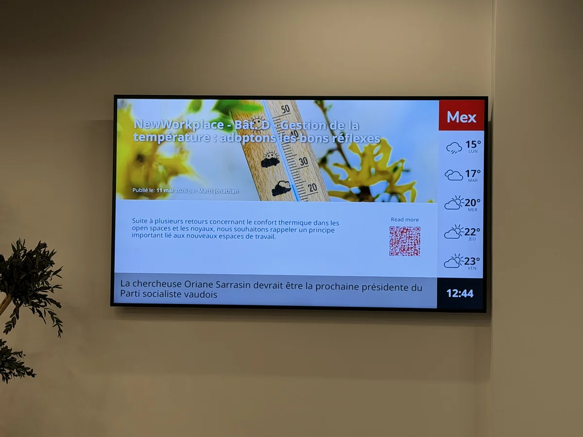 office display in a renovated BOBST production hall showing SharePoint news